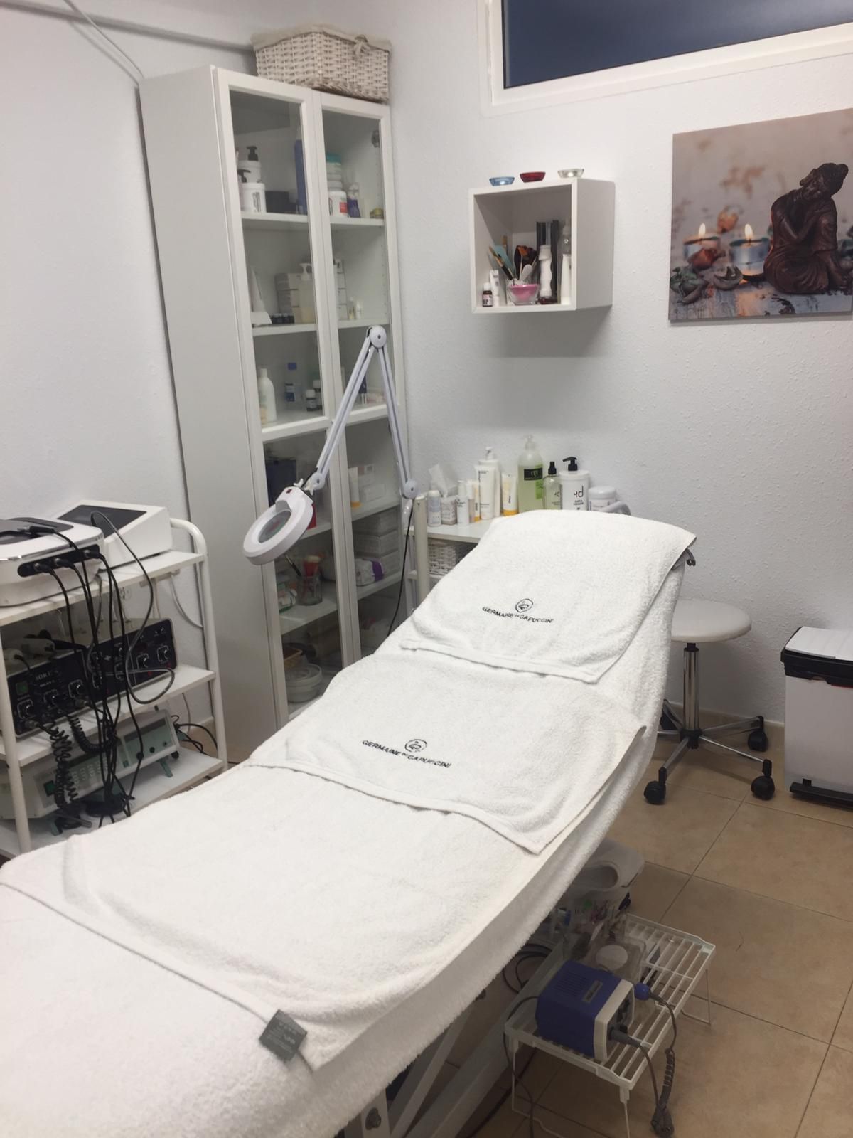 Cabina de estética con camilla, lupa con luz y aparatología